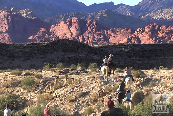 Picture of riders and the Calico Hills at sunset at Cowboy Trail Rides taken while Horseback Riding in Las Vegas